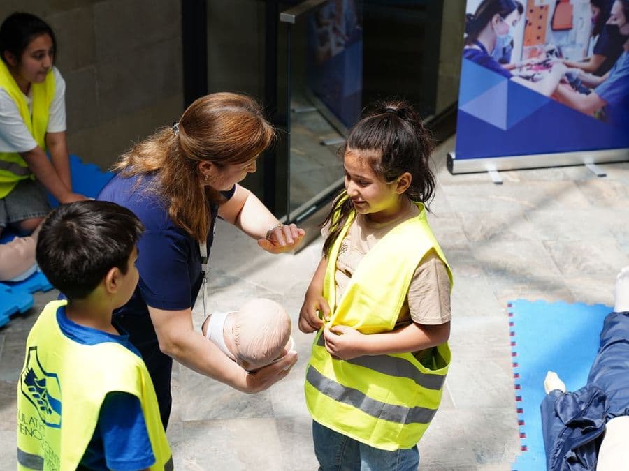 An instructor teaching CPR to a community group