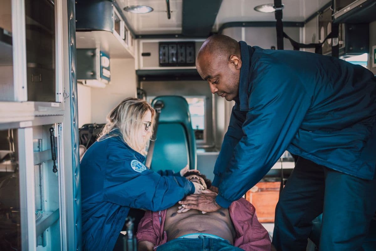 An emergency medical team working a patient during advanced resuscitation