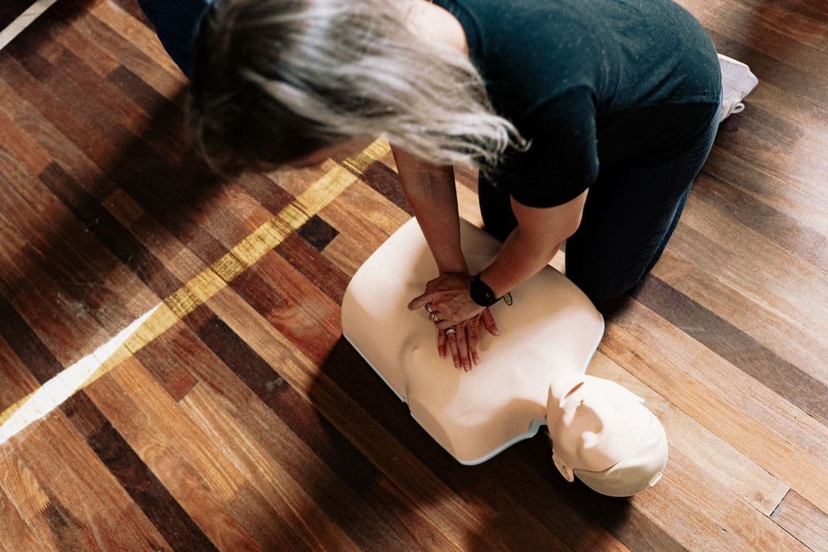 Chest compressions being practised on a CPR training manikin