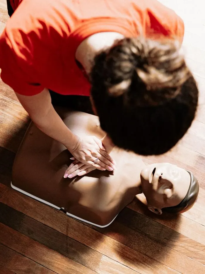 Chest compressions being practised on a CPR training manikin