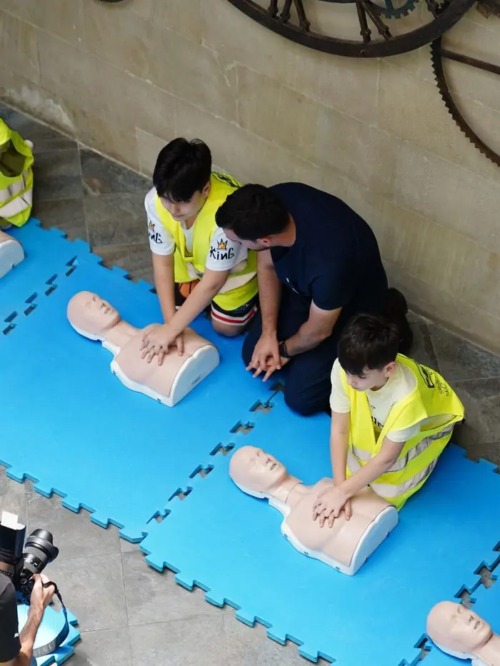 A large group working through CPR practice on manikins